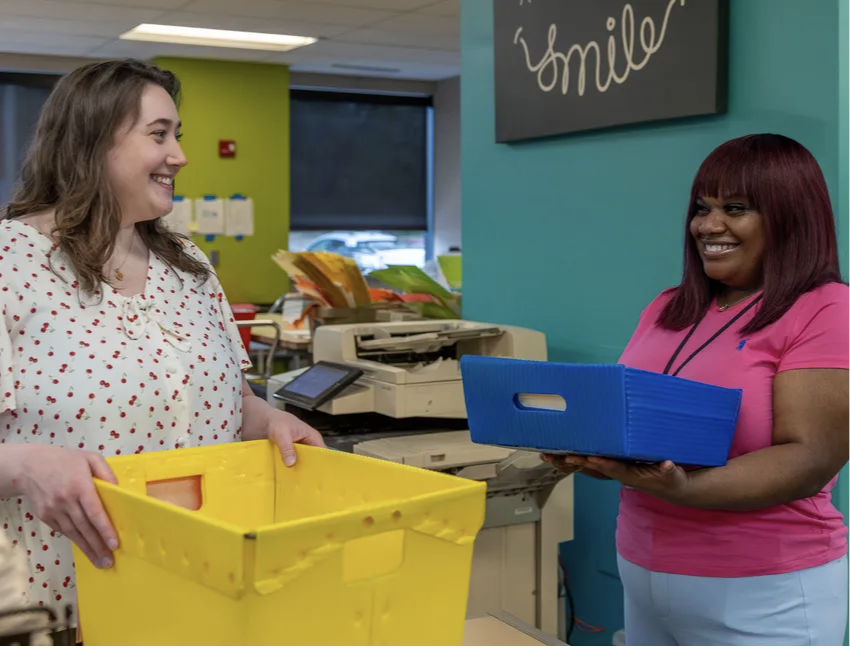 Two happy employees engaging at work.